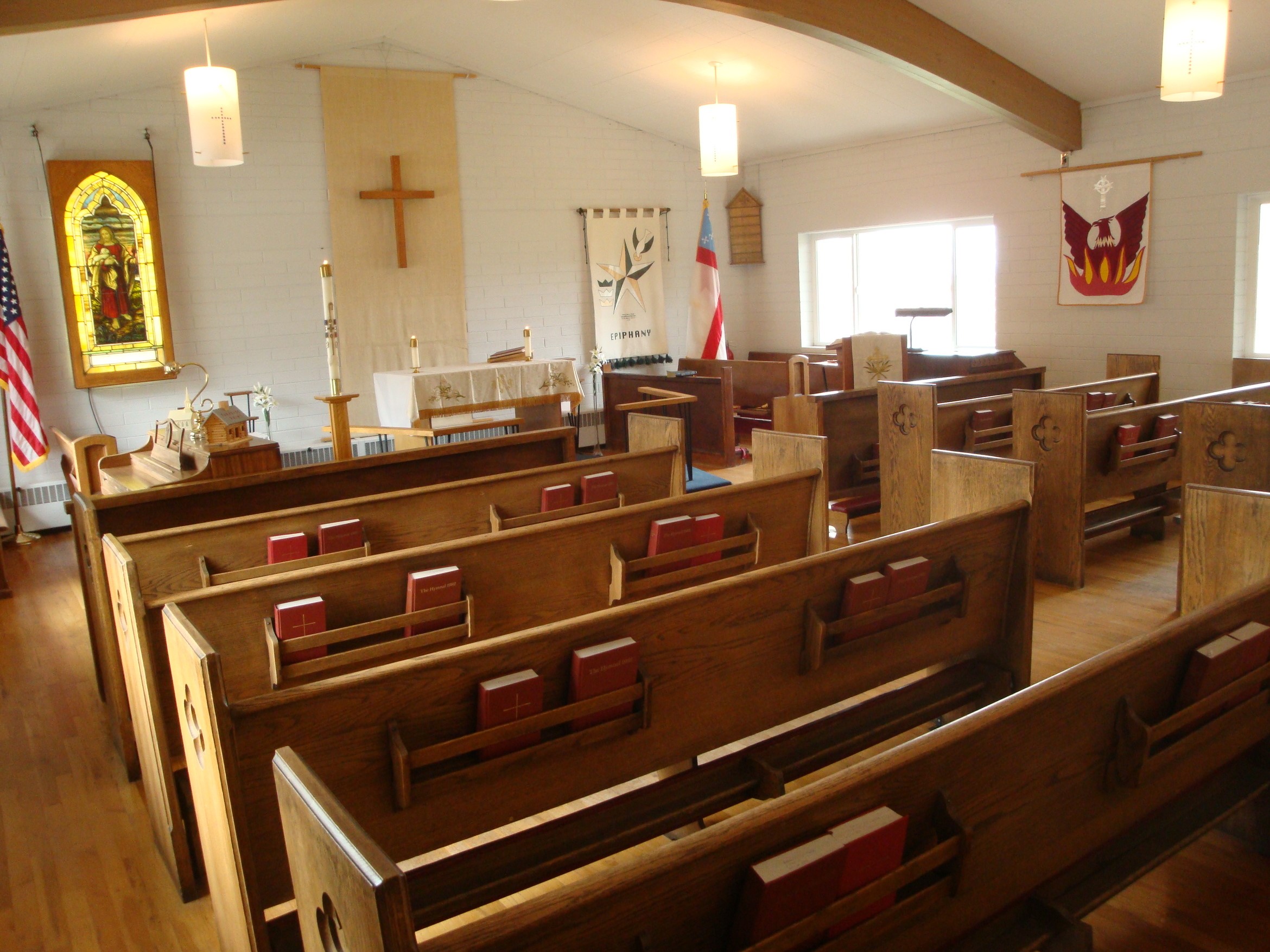 Empty church sanctuary decorated with white hangings